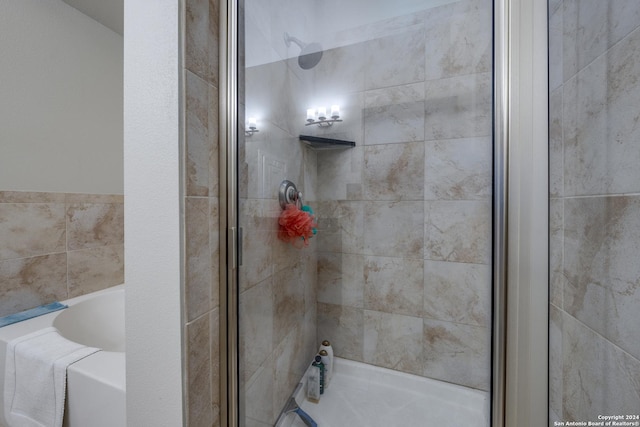 bathroom with separate shower and tub