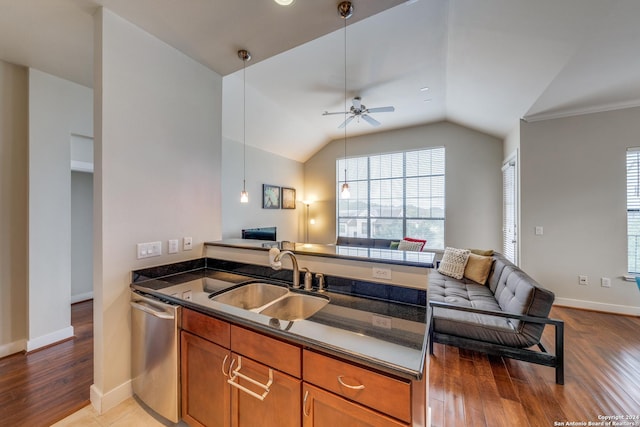 kitchen with dishwasher, sink, kitchen peninsula, and light wood-type flooring