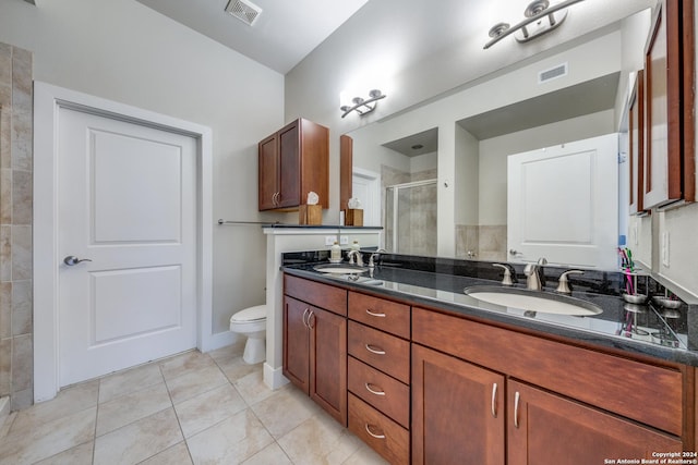 bathroom featuring vanity, tile patterned flooring, a shower with shower door, and toilet