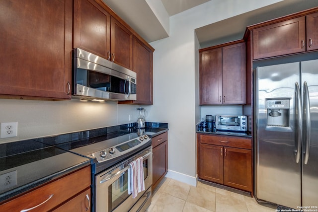 kitchen with stainless steel appliances and light tile patterned floors