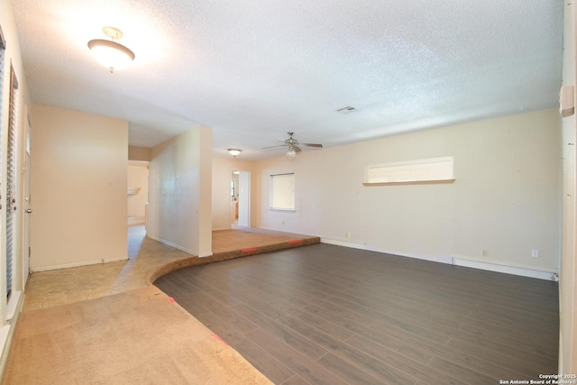 empty room featuring hardwood / wood-style floors, a textured ceiling, and ceiling fan