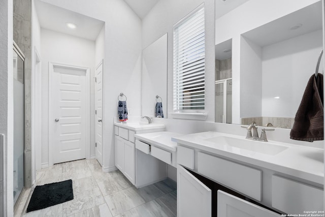 bathroom featuring vanity and a shower with shower door