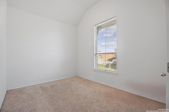 unfurnished room with carpet, vaulted ceiling, and a healthy amount of sunlight