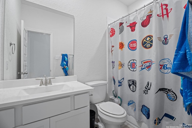 full bathroom with vanity, shower / tub combo, and toilet