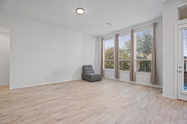 unfurnished room with light wood-type flooring