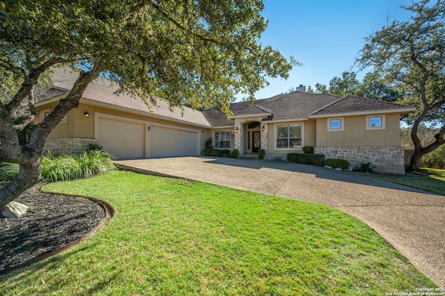 single story home with a front yard and a garage