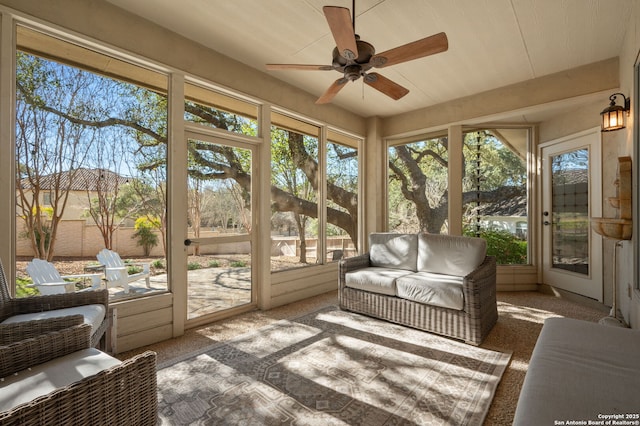 sunroom / solarium featuring ceiling fan