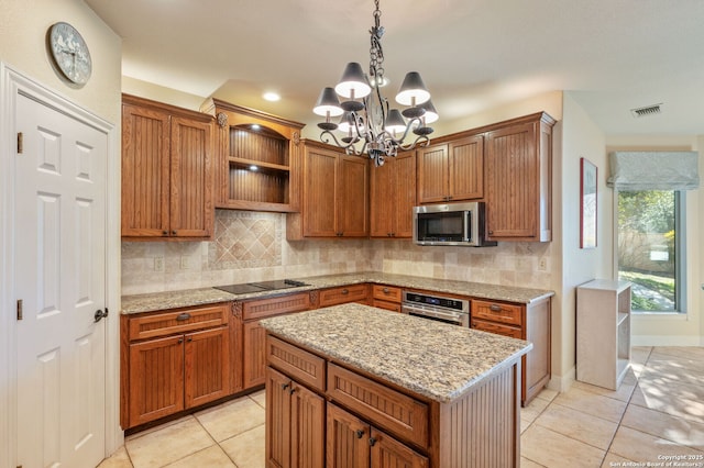 kitchen with decorative backsplash, stainless steel appliances, decorative light fixtures, a chandelier, and a kitchen island