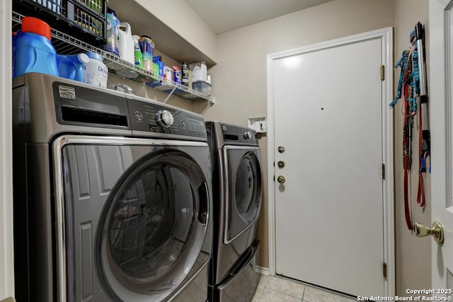 washroom with washing machine and dryer and light tile patterned floors