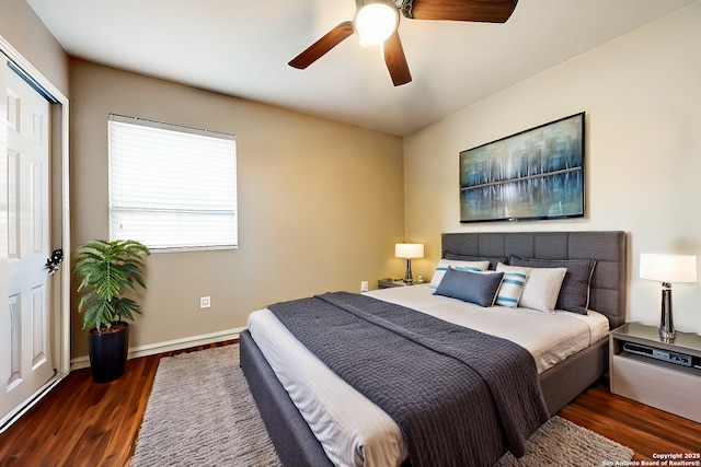 bedroom featuring ceiling fan, a closet, and dark wood-type flooring