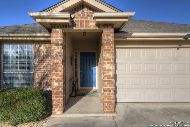 view of exterior entry with a garage