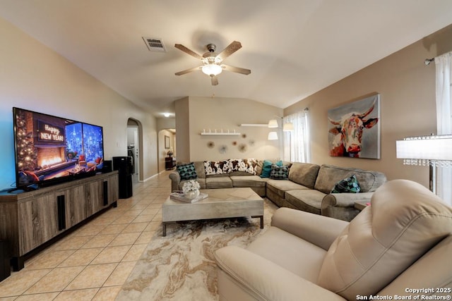 tiled living room with ceiling fan and lofted ceiling