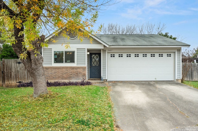 view of front facade with a front yard and a garage