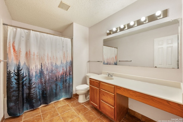 bathroom featuring vanity, a textured ceiling, and toilet