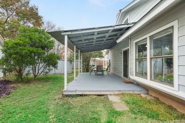 wooden terrace featuring a yard