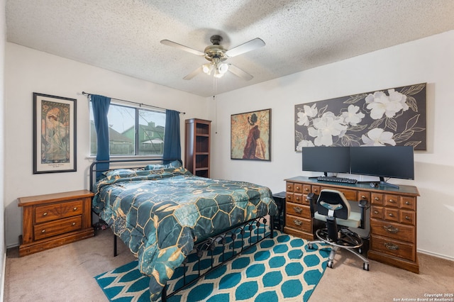 carpeted bedroom featuring ceiling fan and a textured ceiling