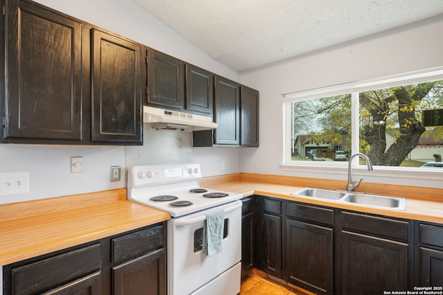 kitchen featuring electric stove, sink, a textured ceiling, dark brown cabinets, and light tile patterned flooring