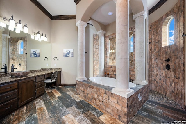 bathroom featuring decorative columns, crown molding, vanity, and plus walk in shower