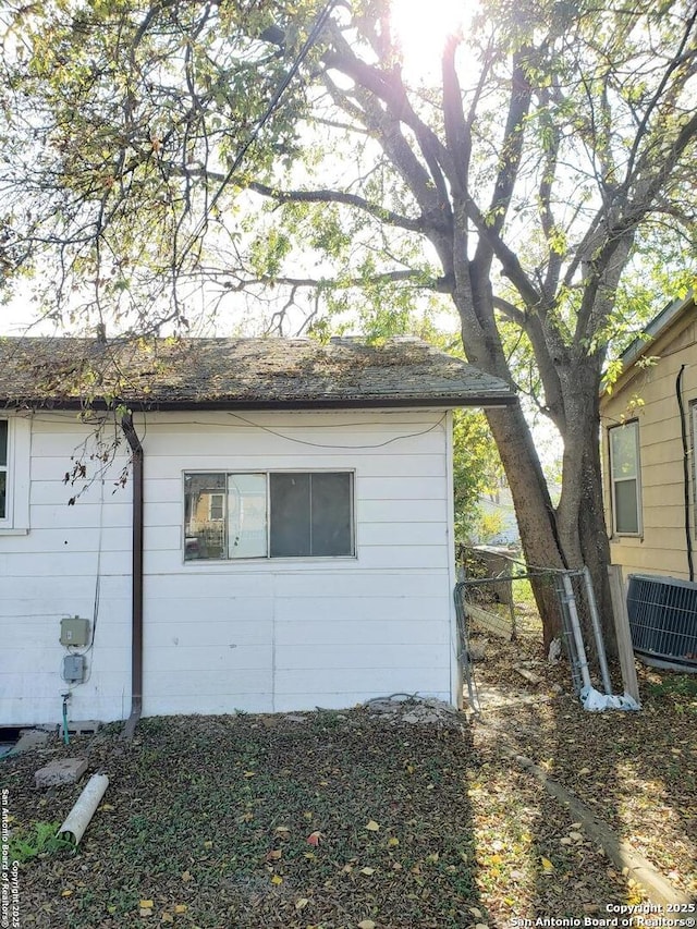 view of side of property with central AC unit