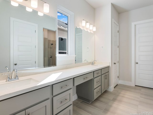 bathroom with vanity and a shower