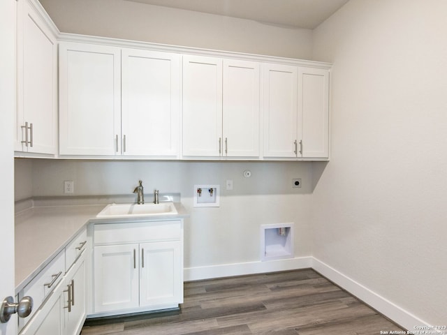 clothes washing area with hookup for an electric dryer, washer hookup, cabinets, dark wood-type flooring, and sink