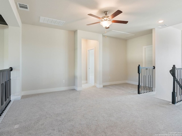 unfurnished living room featuring ceiling fan and light colored carpet