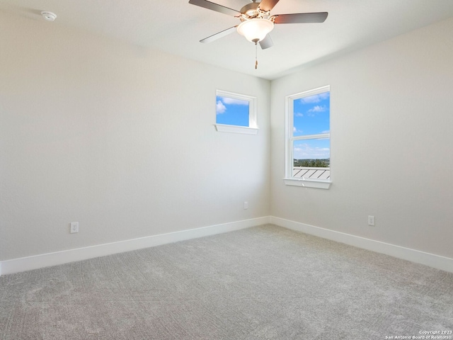 empty room featuring ceiling fan and carpet floors