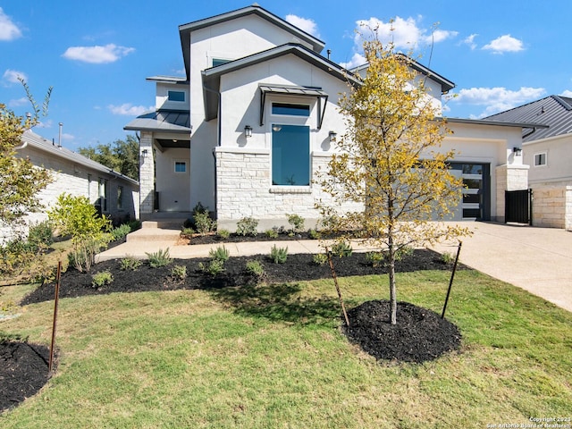 view of front of property with a garage and a front yard