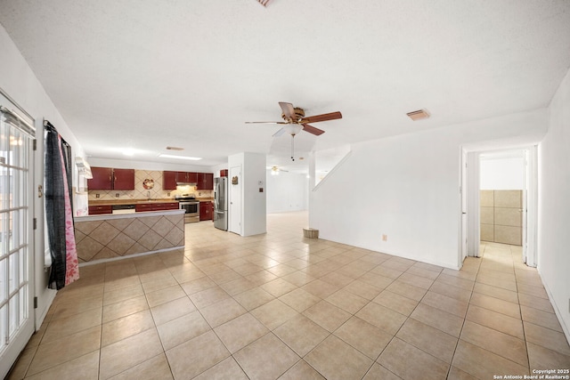 unfurnished living room featuring ceiling fan and light tile patterned flooring