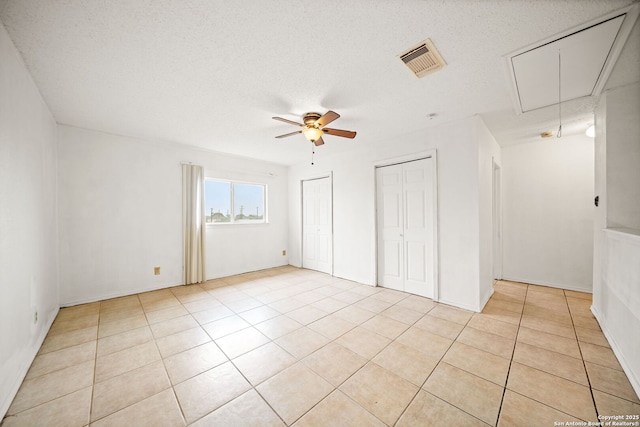 interior space with a textured ceiling and ceiling fan