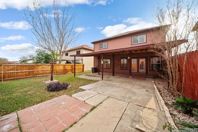 back of property featuring a yard, a patio, and french doors