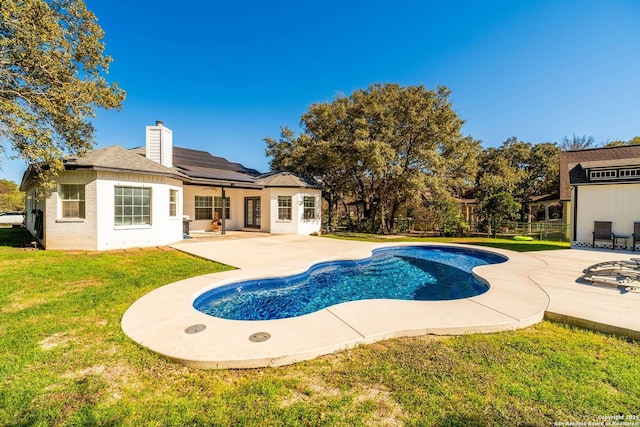 view of swimming pool featuring a patio and a lawn