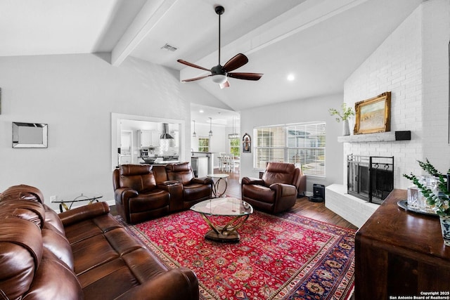 living room with beam ceiling, ceiling fan, a brick fireplace, high vaulted ceiling, and wood-type flooring