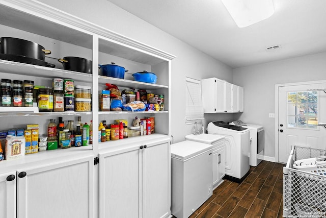 laundry area featuring washer and dryer, cabinets, and sink