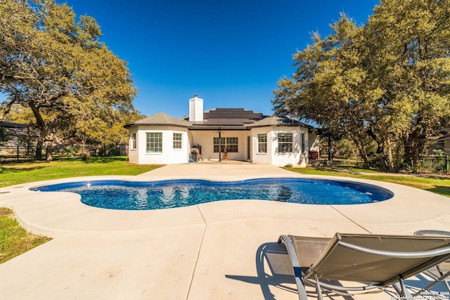 view of pool with a patio area and a lawn