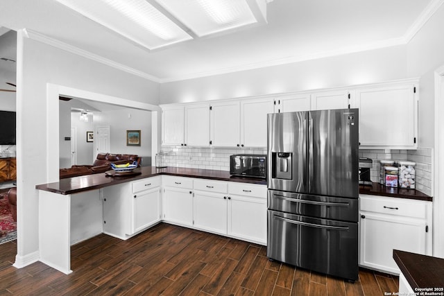 kitchen with white cabinets, stainless steel fridge with ice dispenser, and tasteful backsplash