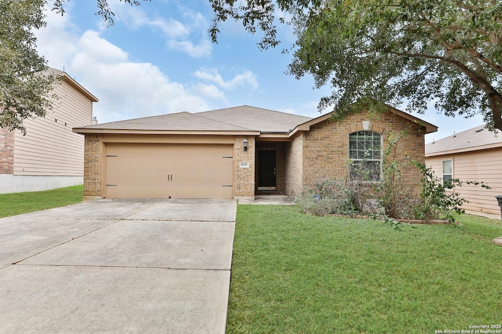 single story home with a front yard and a garage