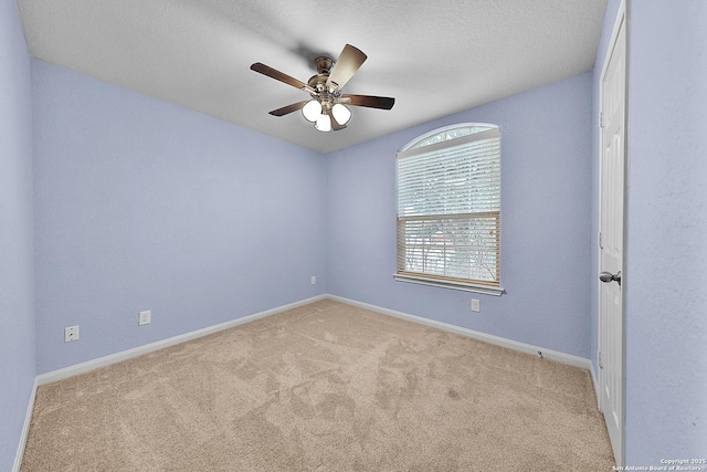 spare room with light carpet and ceiling fan