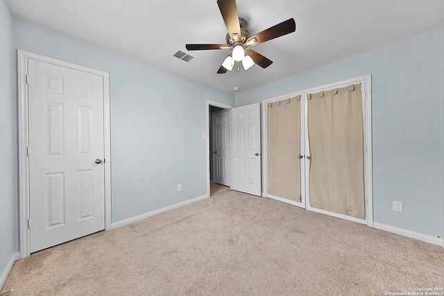 unfurnished bedroom featuring ceiling fan and light carpet