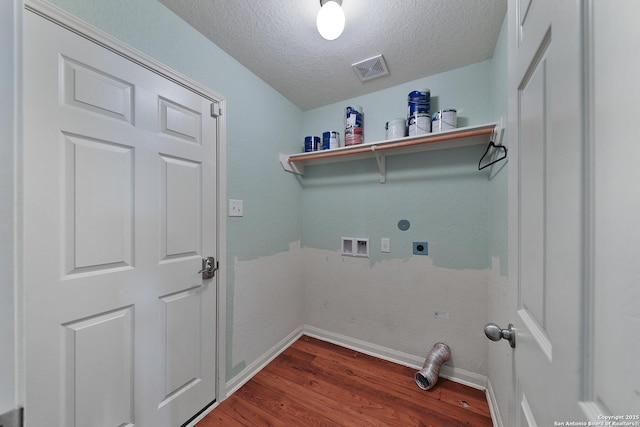 laundry area featuring hookup for a washing machine, a textured ceiling, electric dryer hookup, and hardwood / wood-style floors