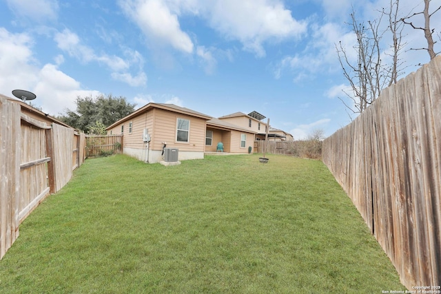 back of house with a lawn and central AC