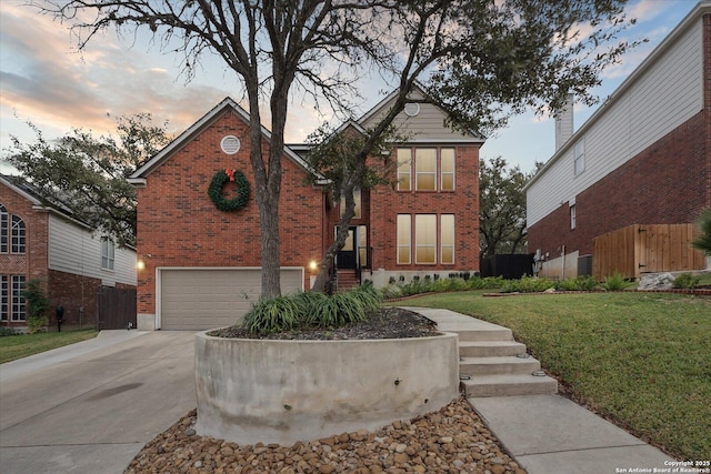 view of front of house with a yard and a garage