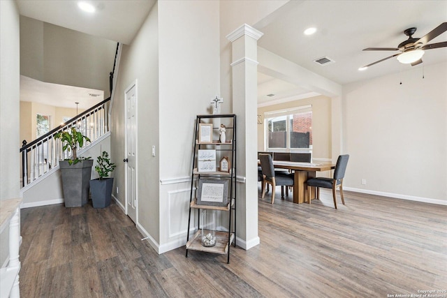 interior space featuring dark hardwood / wood-style floors and decorative columns