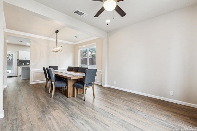 dining room with ceiling fan and hardwood / wood-style floors