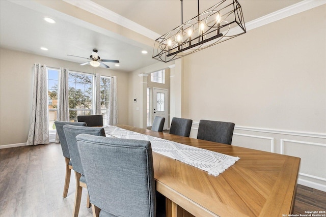 dining area featuring hardwood / wood-style flooring, ceiling fan, and ornamental molding