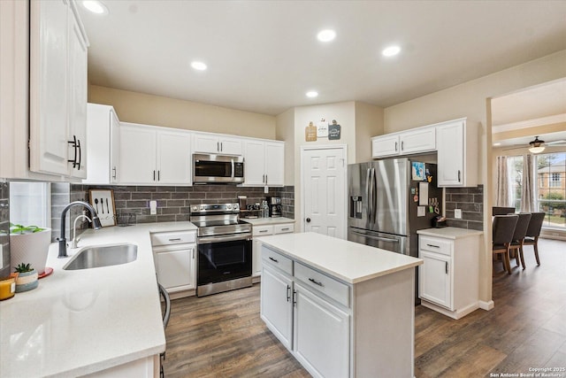 kitchen featuring white cabinets, a kitchen island, and stainless steel appliances