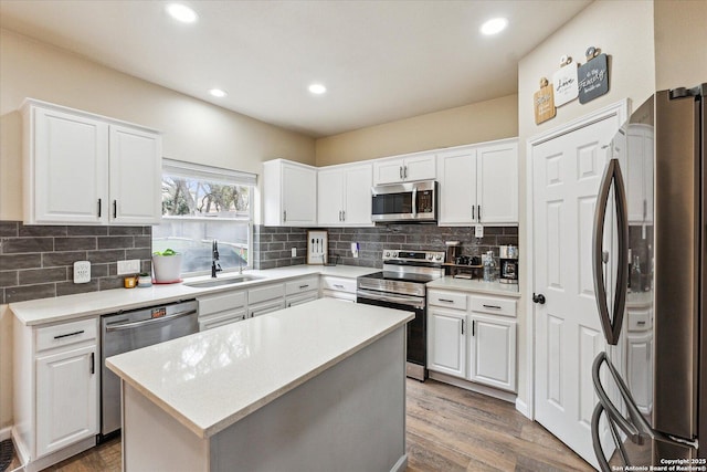 kitchen with a kitchen island, white cabinetry, and stainless steel appliances