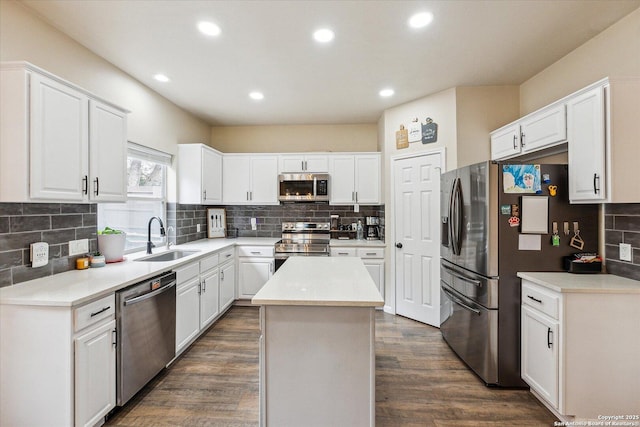 kitchen with white cabinets, stainless steel appliances, and a kitchen island