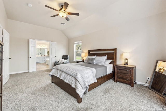 carpeted bedroom featuring ceiling fan, lofted ceiling, and ensuite bath