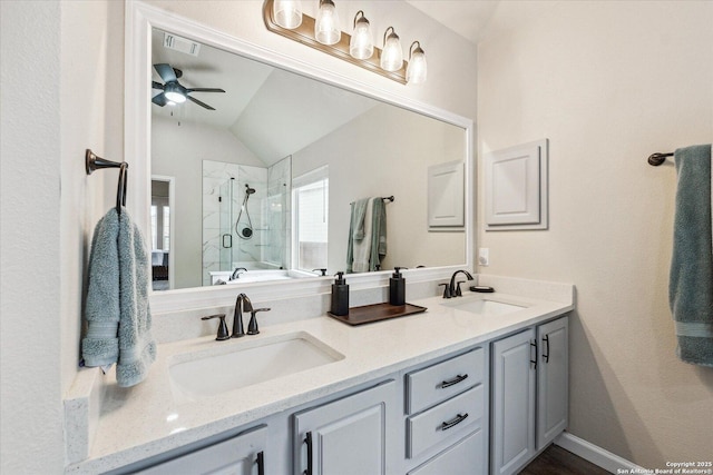 bathroom featuring vanity, a shower with door, vaulted ceiling, and ceiling fan